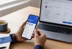 A person compares a phone wallet balance and a laptop checkout page while working out how to buy an Amazon gift card with PayPal.