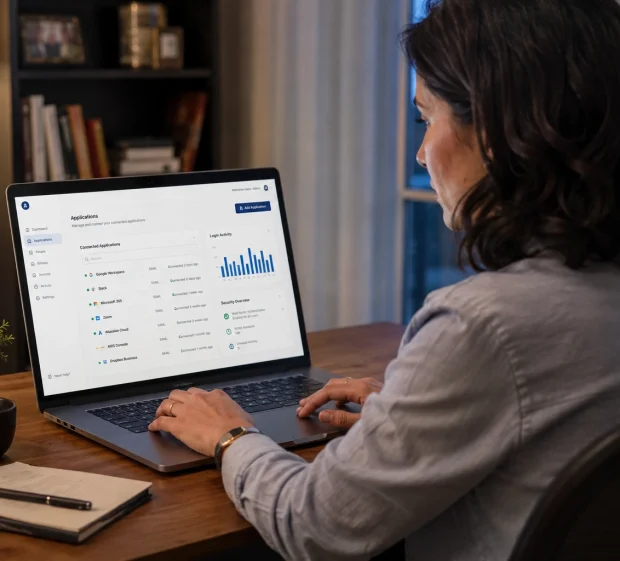 A remote worker at a home desk using a secure remote access dashboard showing connected applications and login activity.