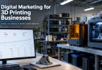 A 3D printing workshop with two printers running beside a monitor showing a search performance dashboard, titled "Digital Marketing for 3D Printing Businesses.