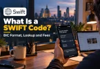 What is a SWIFT code: a freelancer checks his bank's SWIFT/BIC code on a phone before sending it to an overseas client.
